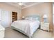 Bright bedroom features a ceiling fan, coastal decor, and a door that leads to the ensuite bathroom at 6015 Catalina Dr. # 134, North Myrtle Beach, SC 29582