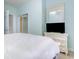 A cozy bedroom with white furniture, neutral walls and carpet, and mirror closet doors at 6015 Catalina Dr. # 134, North Myrtle Beach, SC 29582