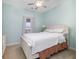 A bedroom with a white bed, dresser and a window letting in natural light at 6015 Catalina Dr. # 134, North Myrtle Beach, SC 29582