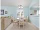 This dining area features a round table with four chairs and a window for natural light at 6015 Catalina Dr. # 134, North Myrtle Beach, SC 29582