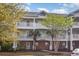 Condo exterior features multiple balconies, brick accents, and well maintained landscaping at 6015 Catalina Dr. # 134, North Myrtle Beach, SC 29582