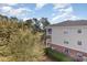 Exterior condo view showcases a side view with ample outdoor living spaces with landscaping at 6015 Catalina Dr. # 134, North Myrtle Beach, SC 29582