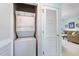 Convenient laundry closet with a stackable washer and dryer, next to a door leading to the living room at 6015 Catalina Dr. # 134, North Myrtle Beach, SC 29582