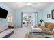 Relaxing living room featuring vaulted ceilings and access to a balcony with outdoor seating at 6015 Catalina Dr. # 134, North Myrtle Beach, SC 29582