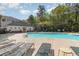 Outdoor pool with lounge chairs, picnic tables, bathroom facilities, and lush landscaping at 6015 Catalina Dr. # 134, North Myrtle Beach, SC 29582