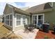 Backyard patio area with seating and exterior of home with enclosed sunroom, ideal for outdoor entertaining at 6172 Catalina Dr. # 612, North Myrtle Beach, SC 29582