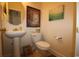 This well-lit bathroom features a pedestal sink, toilet, and beach-themed decor for a relaxing atmosphere at 6172 Catalina Dr. # 612, North Myrtle Beach, SC 29582
