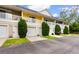 Colorful townhomes show ground floor garages, second story balconies, and trimmed shrubs at 6500 Colonial Dr. # 2, Myrtle Beach, SC 29572