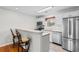 Efficient kitchen featuring stainless steel appliances, breakfast bar, and neutral countertops at 6500 Colonial Dr. # 2, Myrtle Beach, SC 29572
