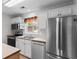 Well-equipped kitchen featuring stainless steel appliances, white cabinets, and a bright window at 6500 Colonial Dr. # 2, Myrtle Beach, SC 29572