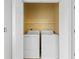 A laundry room is shown with a washer and dryer behind white double doors at 6500 Colonial Dr. # 2, Myrtle Beach, SC 29572