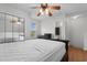 Bedroom featuring hardwood floors, mirrored closet doors, and ceiling fan fixture at 6500 Colonial Dr. # 2, Myrtle Beach, SC 29572