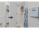 Bathroom with white shower stall, blue floral curtain, and washing machine through the white door at 6630 W Sweetbriar Trail, Myrtle Beach, SC 29588