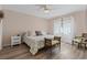 Comfortable bedroom with hardwood floors, floral bedding, and a ceiling fan at 6630 W Sweetbriar Trail, Myrtle Beach, SC 29588