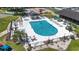 Community pool with lounge chairs and a hot tub, surrounded by well manicured green space at 6630 W Sweetbriar Trail, Myrtle Beach, SC 29588