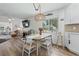 Inviting dining area with a wooden table, stylish chairs, and a view of the lush outdoors at 6630 W Sweetbriar Trail, Myrtle Beach, SC 29588