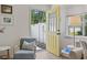 Bright entryway with wood floors, a yellow door, and natural lighting at 6630 W Sweetbriar Trail, Myrtle Beach, SC 29588