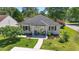 Charming single-story home featuring a well-manicured lawn, inviting front porch with rocking chairs, and lovely landscaping at 6630 W Sweetbriar Trail, Myrtle Beach, SC 29588