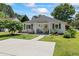 Charming single-story home with a well-manicured lawn and inviting front porch with rocking chairs at 6630 W Sweetbriar Trail, Myrtle Beach, SC 29588