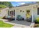 Inviting front porch with comfortable seating, lovely flower boxes, and a bright yellow door at 6630 W Sweetbriar Trail, Myrtle Beach, SC 29588