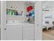 Laundry closet with washer, dryer, and shelves for storage, conveniently located near the bedroom at 6630 W Sweetbriar Trail, Myrtle Beach, SC 29588