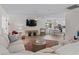 Bright living room with comfortable seating, a flat-screen TV, and an open kitchen, creating a welcoming atmosphere at 6630 W Sweetbriar Trail, Myrtle Beach, SC 29588