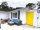 Relaxing patio area featuring cozy seating and a bright yellow accent door at 6630 W Sweetbriar Trail, Myrtle Beach, SC 29588