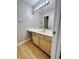 Bathroom with wood cabinets and neutral wallpaper at 665 Tupelo Ln. # 17-D, Longs, SC 29568