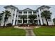 Beautiful three story condo with lush landscaping, tall white columns, and outdoor balconies at 665 Tupelo Ln. # 17-D, Longs, SC 29568