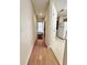 Inviting hallway with neutral walls, wood-look floors, and a view of the door to the exterior at 665 Tupelo Ln. # 17-D, Longs, SC 29568