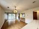 Open-concept living room with wood floors, lots of light, and access to a balcony at 665 Tupelo Ln. # 17-D, Longs, SC 29568