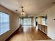 Bright living room showcasing wood floors, big windows, and access to a relaxing balcony at 665 Tupelo Ln. # 17-D, Longs, SC 29568