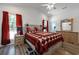 Comfortable bedroom featuring a ceiling fan, wood-look flooring, and bright natural light from the windows at 67 Bossie Ln., Georgetown, SC 29440