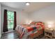 Bright bedroom with neutral paint, bedside lamps, hard wood floors, and large windows for natural light at 67 Bossie Ln., Georgetown, SC 29440