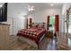 Comfortable bedroom featuring a ceiling fan, wood-look flooring, and bright natural light from the windows at 67 Bossie Ln., Georgetown, SC 29440