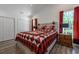 Comfortable bedroom featuring a ceiling fan, wood-look flooring, and bright natural light from the windows at 67 Bossie Ln., Georgetown, SC 29440