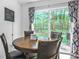 Bright dining area features a wooden table with seating for four and large sliding glass door to the backyard at 67 Bossie Ln., Georgetown, SC 29440