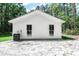 View of the home's white rear exterior featuring an HVAC unit and clean siding at 67 Bossie Ln., Georgetown, SC 29440