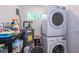 Efficient laundry area with stacked washer and dryer, water heater, storage shelf and natural light at 67 Bossie Ln., Georgetown, SC 29440