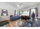 Bright living room features hard wood floors, neutral paint, and large windows for plenty of natural light at 67 Bossie Ln., Georgetown, SC 29440