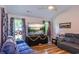 Bright living room features hard wood floors, neutral paint, a ceiling fan, and large tv for entertaining at 67 Bossie Ln., Georgetown, SC 29440