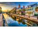 Scenic waterfront view with colorful buildings and palm trees reflecting in the water at sunset at 67 Bossie Ln., Georgetown, SC 29440