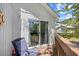 Inviting balcony features a comfortable chair with sliding glass doors, offering a seamless indoor-outdoor living at 739 Tall Oaks Dr., Myrtle Beach, SC 29588