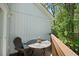 Cozy balcony featuring a stone table, a chair, and a wooded view, perfect for relaxing outdoors at 739 Tall Oaks Dr., Myrtle Beach, SC 29588