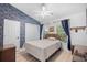 Comfortable bedroom featuring a wicker bed frame, blue accent wall, and natural light from the window at 739 Tall Oaks Dr., Myrtle Beach, SC 29588