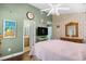 Spacious bedroom featuring an ensuite bathroom, television, ceiling fan, and a dresser with mirror at 739 Tall Oaks Dr., Myrtle Beach, SC 29588