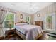 Cozy bedroom with neutral patterned wallpaper, ceiling fan, and ample natural light from windows and access to outdoor space at 739 Tall Oaks Dr., Myrtle Beach, SC 29588