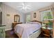 Cozy bedroom features ceiling fan, natural light from windows, and dresser with mirror at 739 Tall Oaks Dr., Myrtle Beach, SC 29588