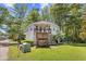 Charming two-story home with a spacious front yard and inviting wooden deck at 739 Tall Oaks Dr., Myrtle Beach, SC 29588