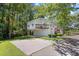 Two-story home featuring a covered garage, elevated deck, and ample parking space at 739 Tall Oaks Dr., Myrtle Beach, SC 29588